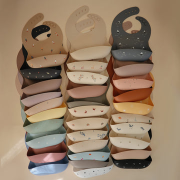 Mushie Silicone Baby Bib | Adjustable Fit Waterproof Bibs (Kites)