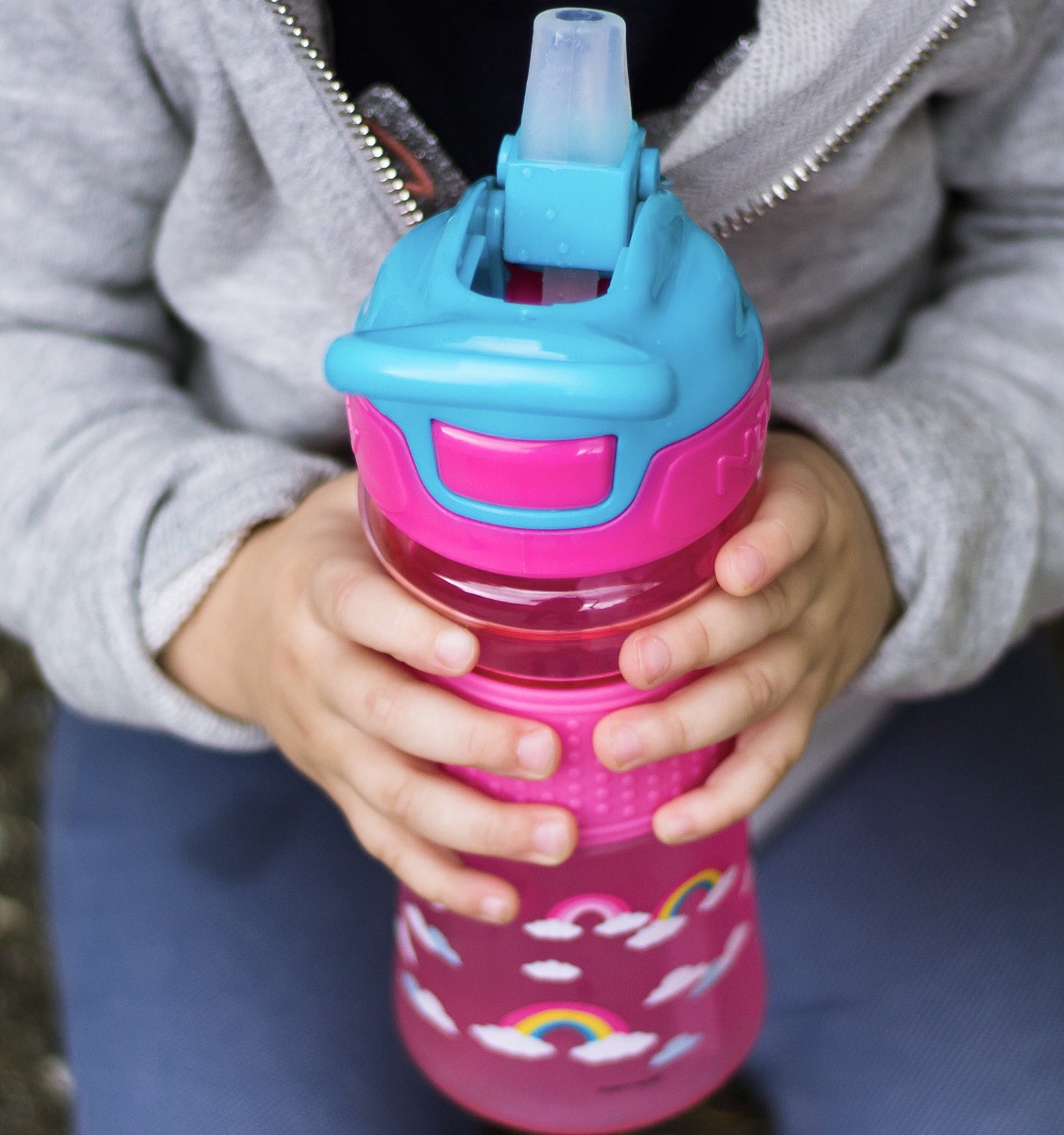 Nuby Thirsty Kids Push Button Flip-It Soft Spout On The Go Water Bottle With Easy Grip Band, Pink Rainbows, 12 Ounce