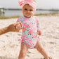 RuffleButts Baby Girls UPF 50+ Sun Protection Tropical Print Long Sleeve One Piece Rash Guard Swimsuit with Zipper - Fab Flaming