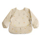 mushie Long Sleeve Baby Bib | Mess Free & Waterproof Fabric for Toddlers | Adjustable Fit for Ages 6-24 Months (Dinos)