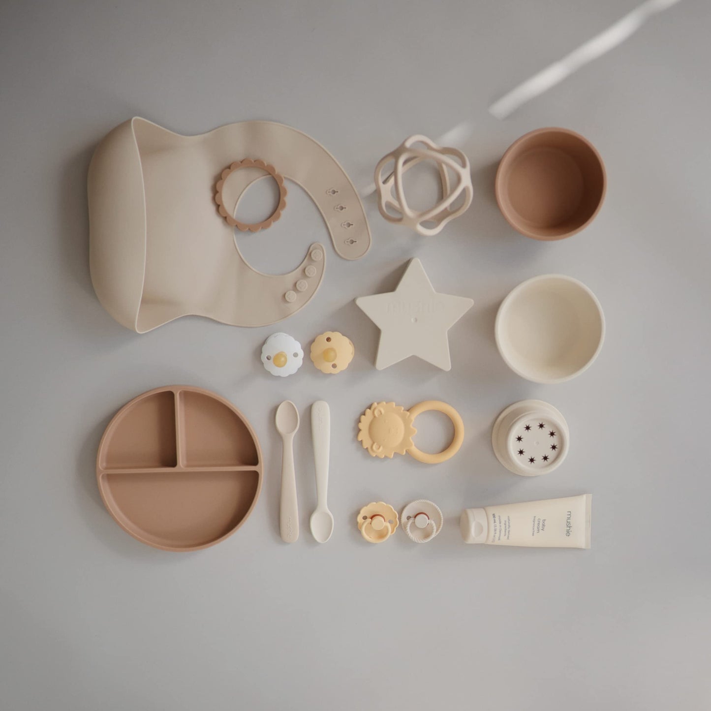 Mushie Silicone Baby Bib | Adjustable Fit Waterproof Bibs (Shifting Sand)