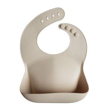 Mushie Silicone Baby Bib | Adjustable Fit Waterproof Bibs (Shifting Sand)