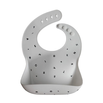 Mushie Silicone Baby Bib | Adjustable Fit Waterproof Bibs (Letters White)