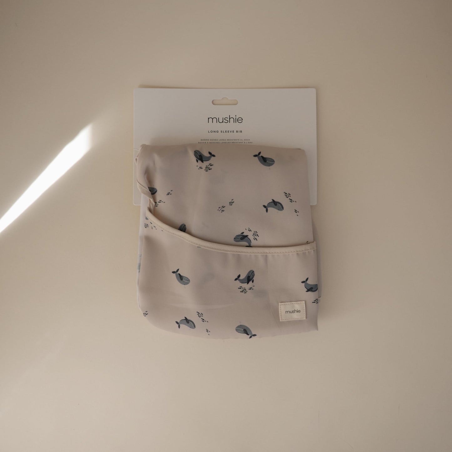 mushie Long Sleeve Baby Bib | Mess Free & Waterproof Fabric for Toddlers | Adjustable Fit for Ages 6-24 Months (Whales)