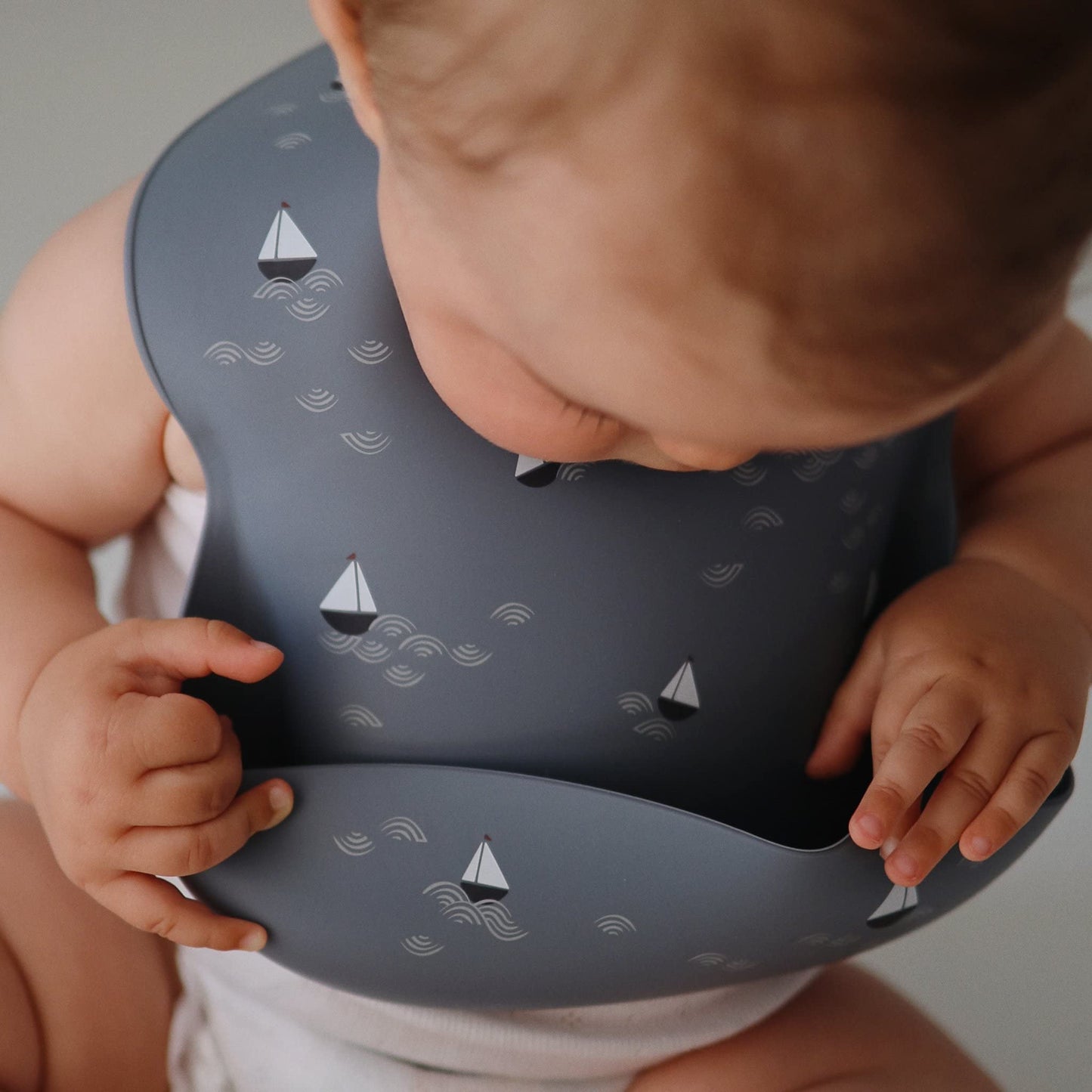 Mushie Silicone Baby Bib | Adjustable Fit Waterproof Bibs (Boats)