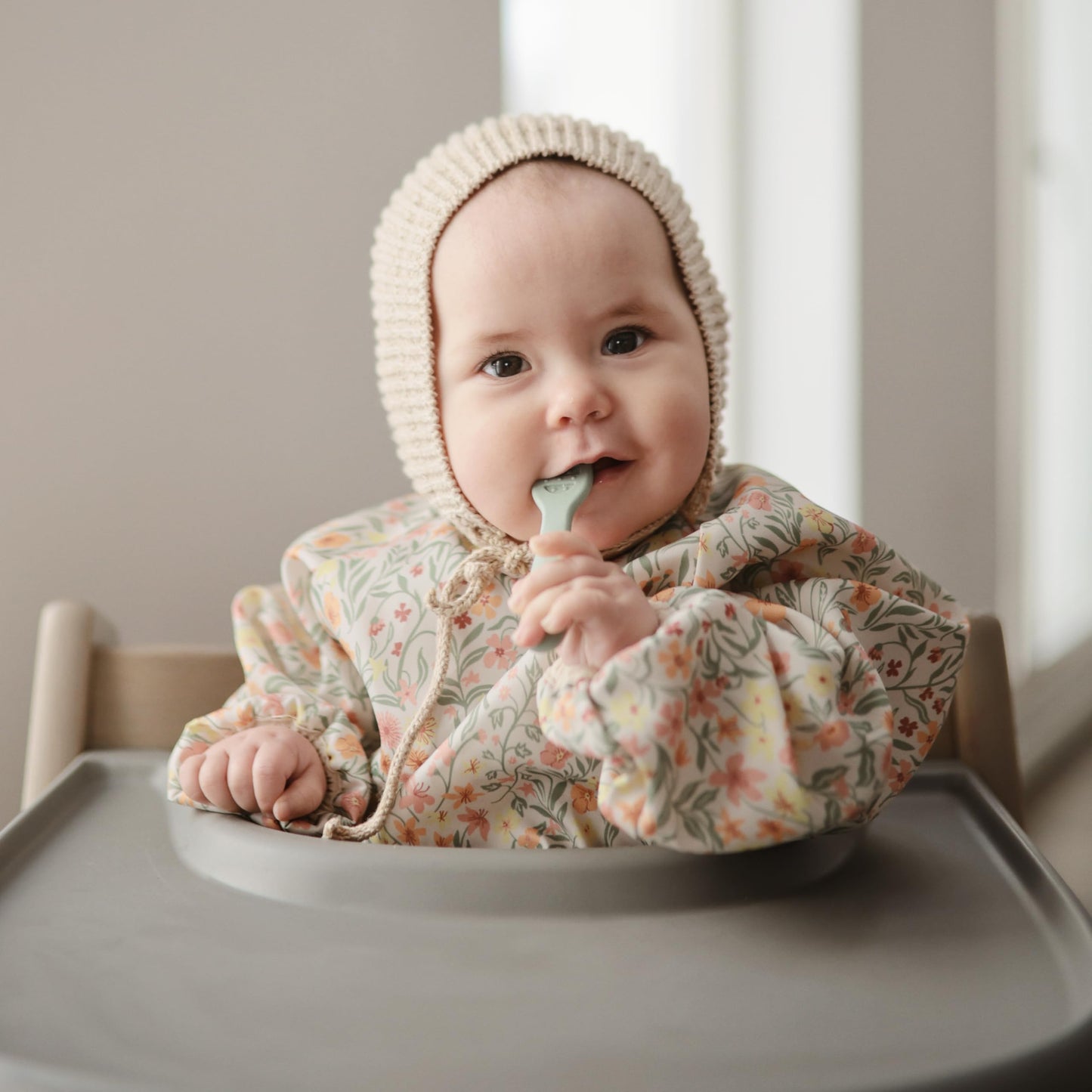 mushie Long Sleeve Baby Bib | Mess Free & Waterproof Fabric for Toddlers | Adjustable Fit for Ages 6-24 Months (Pastel Blooms)