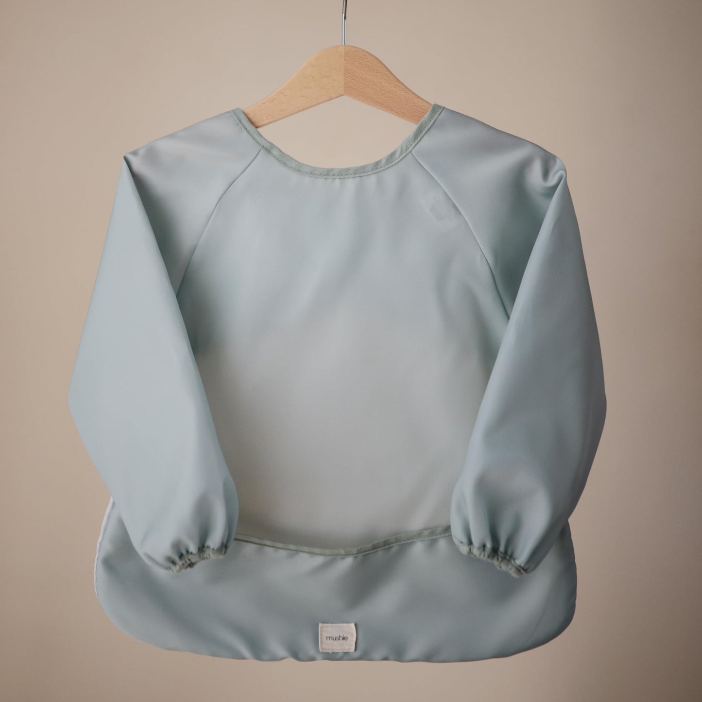 mushie Long Sleeve Baby Bib | Mess Free & Waterproof Fabric for Toddlers | Adjustable Fit for Ages 6-24 Months (Roman Green)