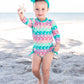 RuffleButts Baby Girls UPF 50+ Sun Protection Novelty Print Long Sleeve One Piece Rash Guard Swimsuit with Zipper - Mermaid/Aqua