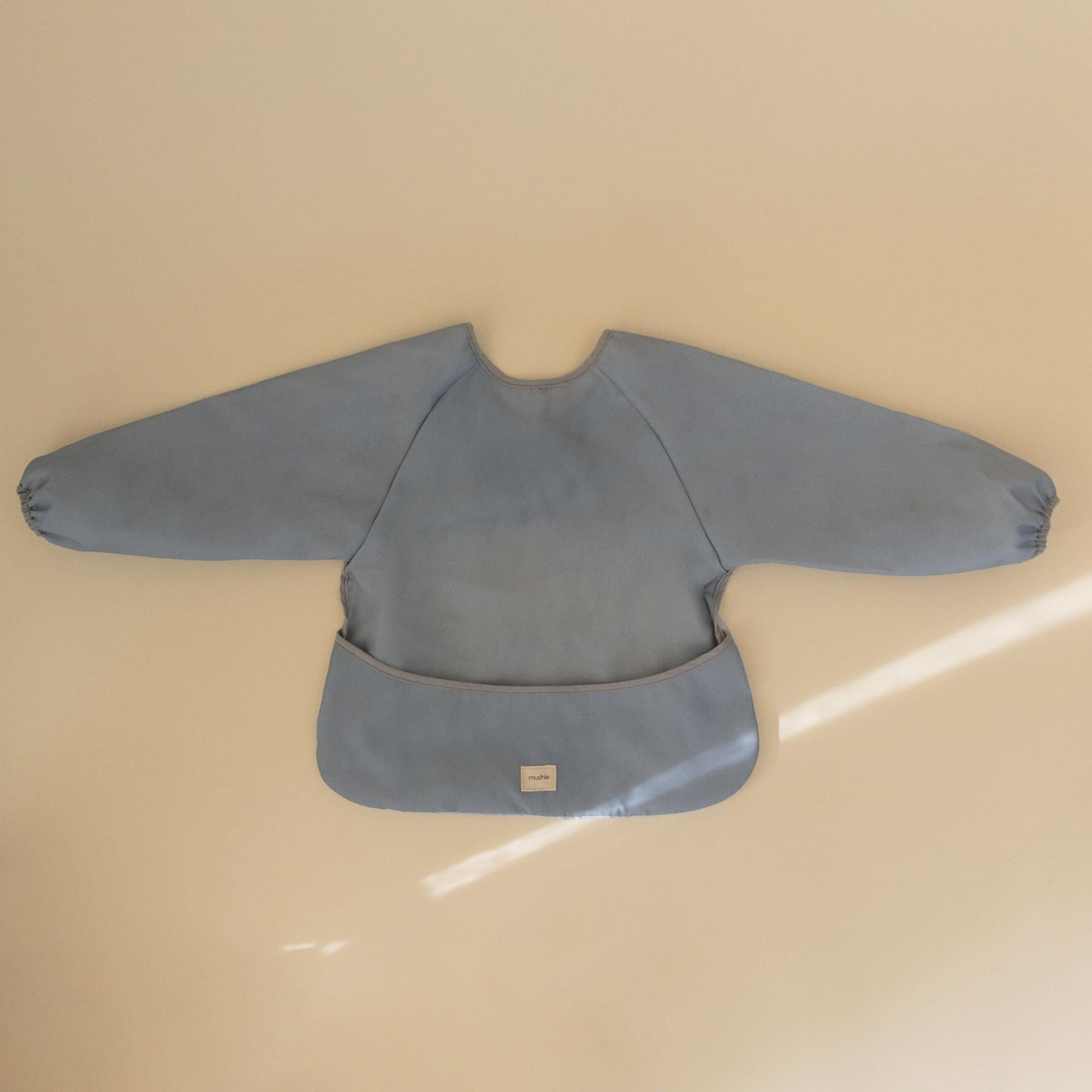 mushie Long Sleeve Baby Bib | Mess Free & Waterproof Fabric for Toddlers | Adjustable Fit for Ages 6-24 Months (Tradewinds)