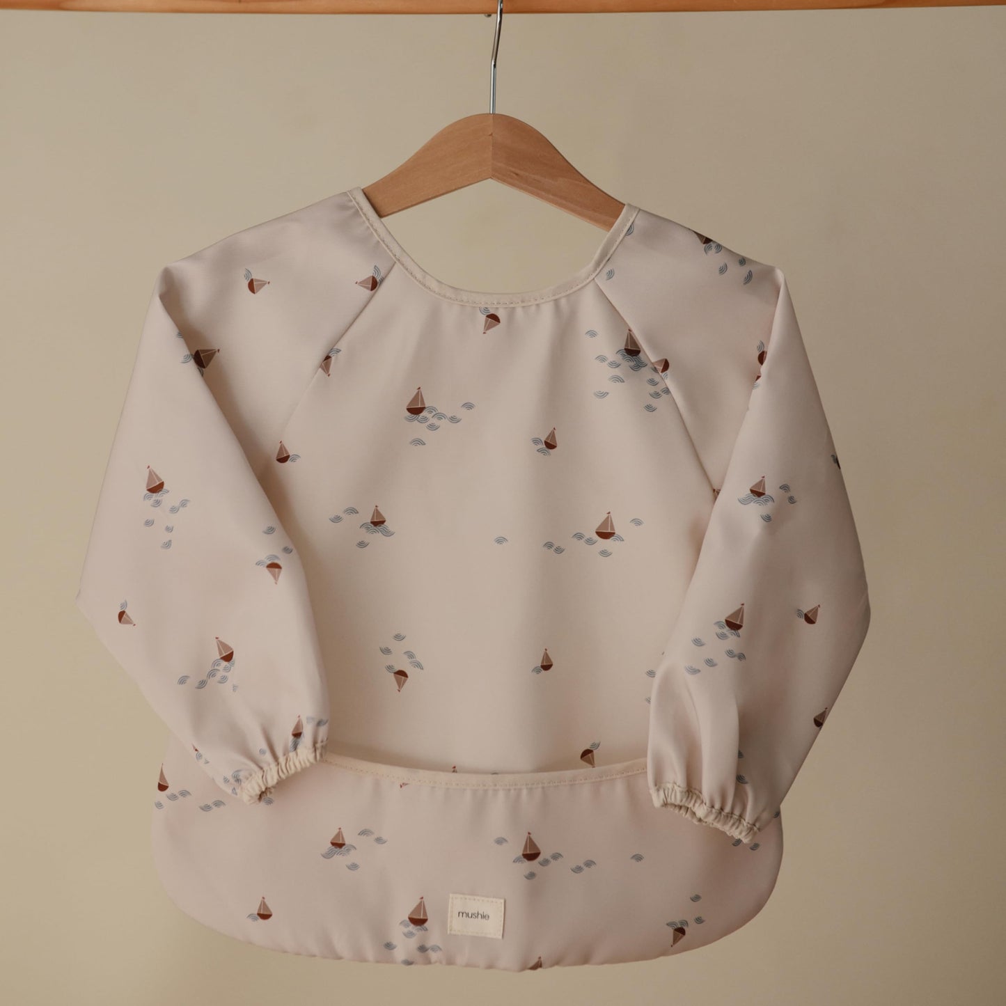 mushie Long Sleeve Baby Bib | Mess Free & Waterproof Fabric for Toddlers | Adjustable Fit for Ages 6-24 Months (Boats)