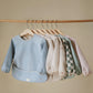 mushie Long Sleeve Baby Bib | Mess Free & Waterproof Fabric for Toddlers | Adjustable Fit for Ages 6-24 Months (Rainbows)