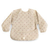 mushie Long Sleeve Baby Bib | Water Resistant Adjustable Fit for Ages 6-24 Months (Cherries)