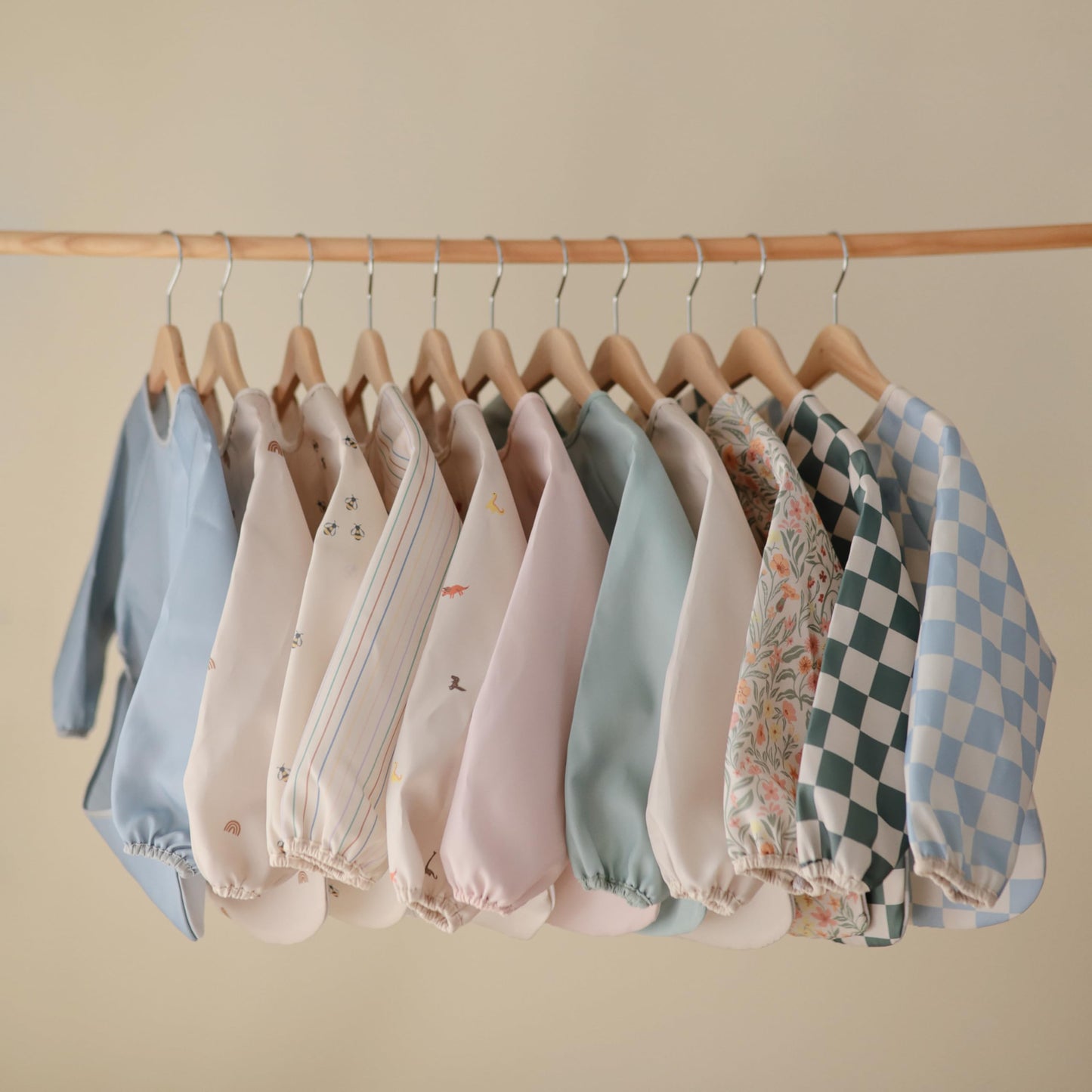 mushie Long Sleeve Baby Bib | Mess Free & Waterproof Fabric for Toddlers | Adjustable Fit for Ages 6-24 Months (Pastel Blooms)