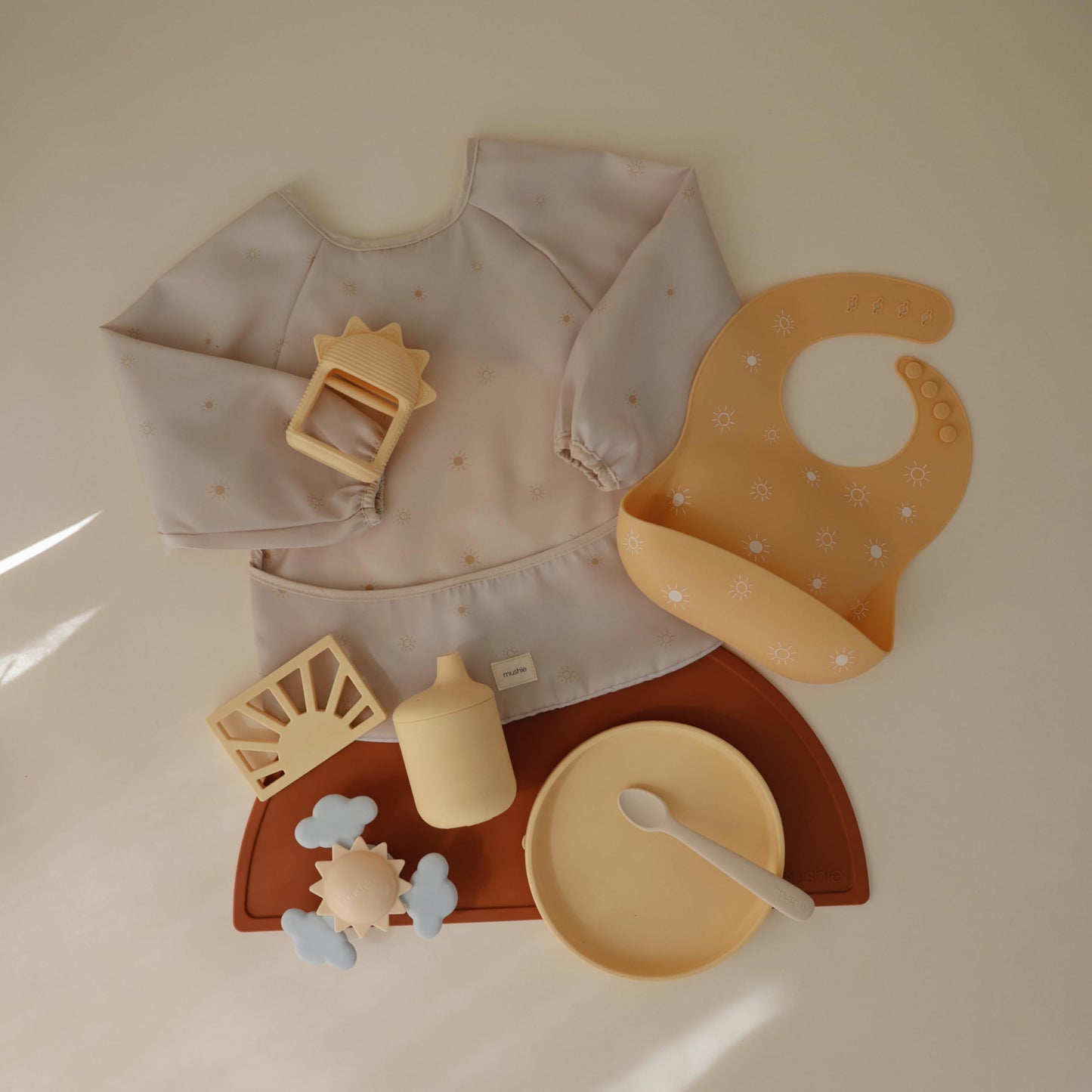 mushie Long Sleeve Baby Bib | Mess Free & Waterproof Fabric for Toddlers | Adjustable Fit for Ages 6-24 Months (Sun)