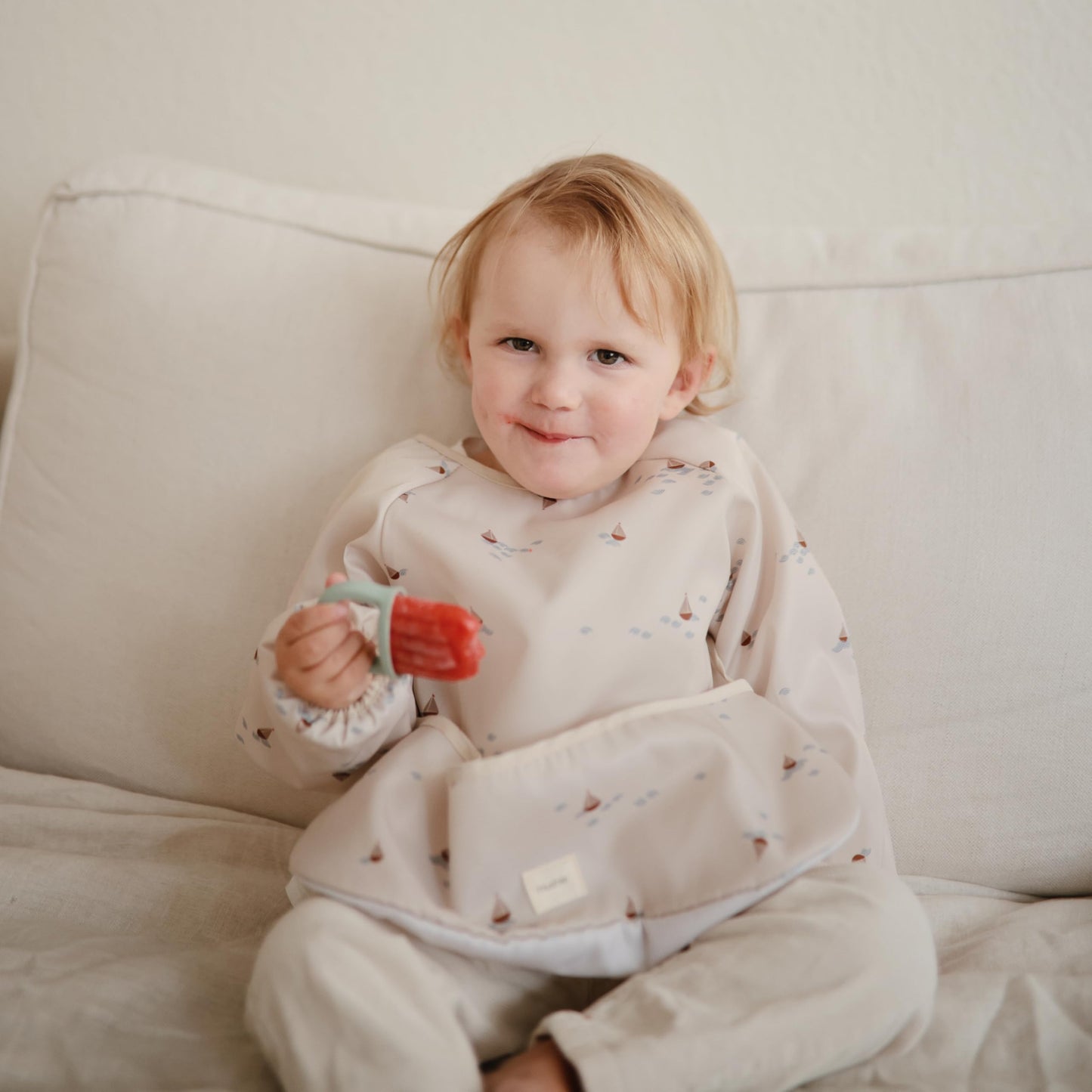 mushie Long Sleeve Baby Bib | Mess Free & Waterproof Fabric for Toddlers | Adjustable Fit for Ages 6-24 Months (Boats)