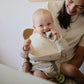 Mushie Silicone Baby Bib | Adjustable Fit Waterproof Bibs (Pretzel)