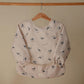mushie Long Sleeve Baby Bib | Mess Free & Waterproof Fabric for Toddlers | Adjustable Fit for Ages 6-24 Months (Whales)