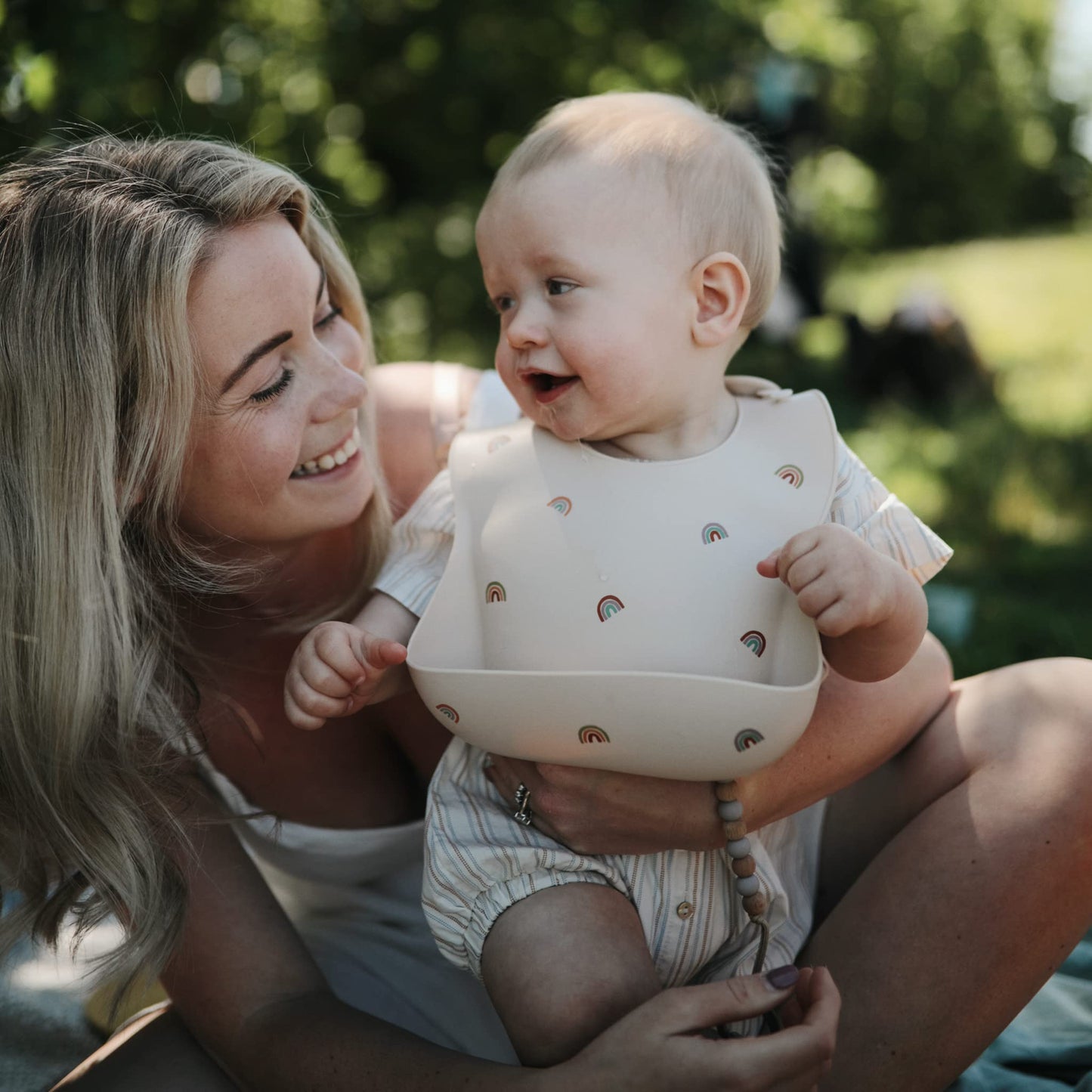 Mushie Silicone Baby Bib | Adjustable Fit Waterproof Bibs (Rainbows)