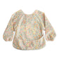 mushie Long Sleeve Baby Bib | Mess Free & Waterproof Fabric for Toddlers | Adjustable Fit for Ages 6-24 Months (Pastel Blooms)
