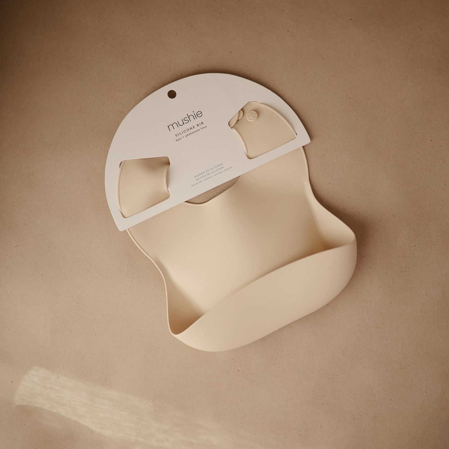 Mushie Silicone Baby Bib | Adjustable Fit Waterproof Bibs (Shifting Sand)