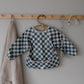 mushie Long Sleeve Baby Bib | Mess Free & Waterproof Fabric for Toddlers | Adjustable Fit for Ages 6-24 Months (Olive Check)