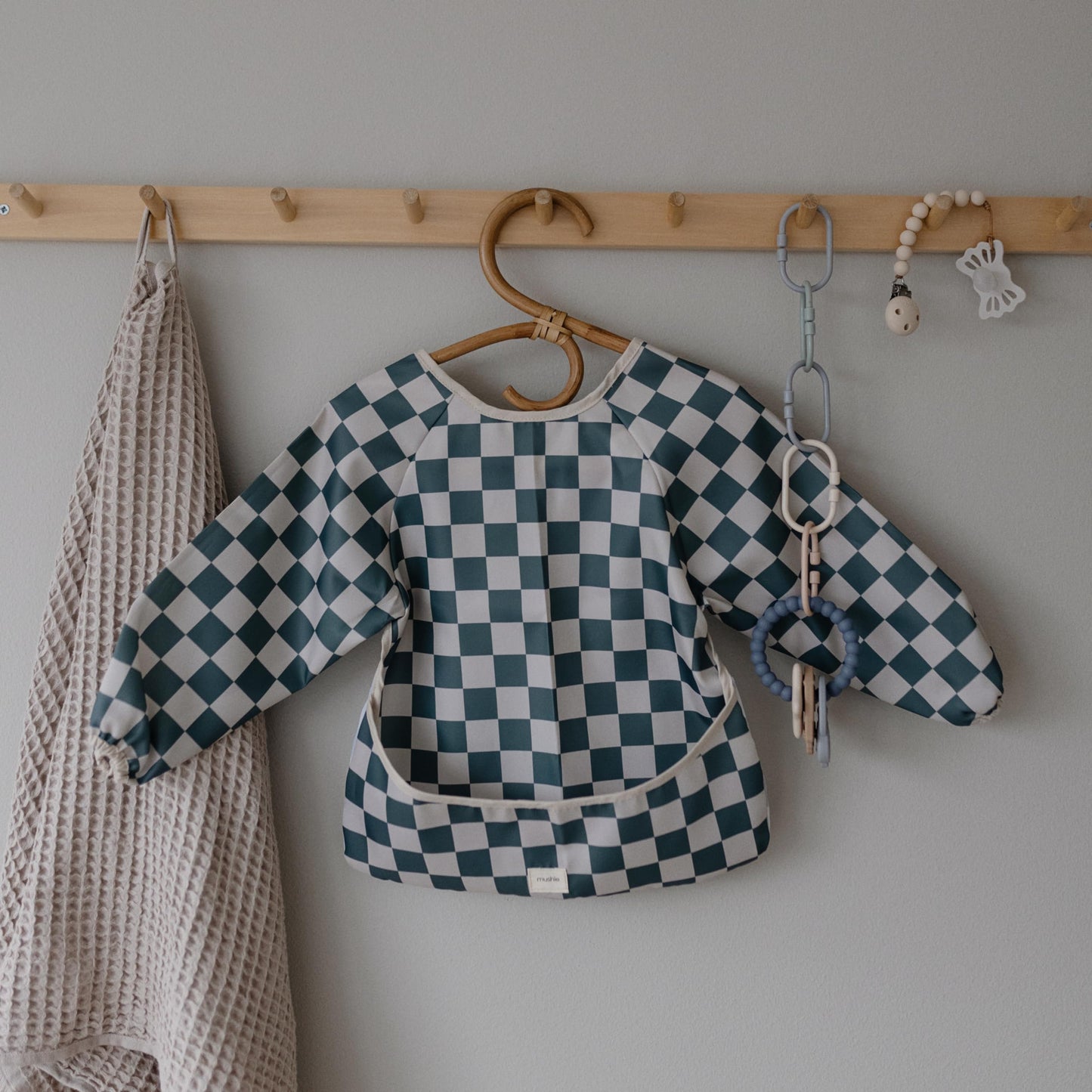 mushie Long Sleeve Baby Bib | Mess Free & Waterproof Fabric for Toddlers | Adjustable Fit for Ages 6-24 Months (Olive Check)