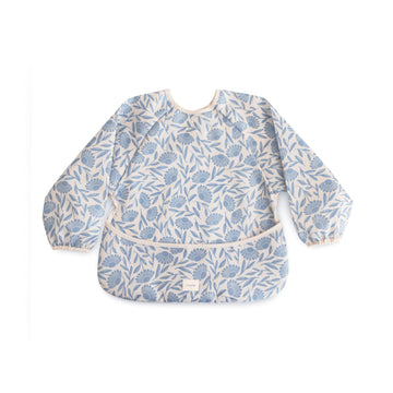 mushie Long Sleeve Baby Bib | Water Resistant Adjustable Fit for Ages 6-24 Months (Blue Flowers)