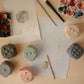 mushie Silicone Dice Press Toy | Baby Sensory Play for 10+ Months (Tradewinds/Stone)