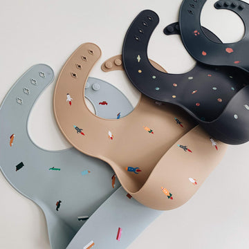 Mushie Silicone Baby Bib | Adjustable Fit Waterproof Bibs (Planets)