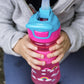 Nuby Thirsty Kids Push Button Flip-It Soft Spout On The Go Water Bottle With Easy Grip Band, Pink Rainbows, 12 Ounce